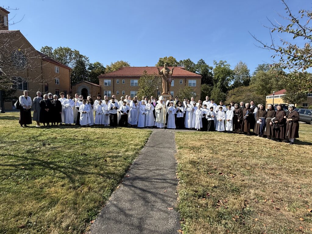 Archdiocese of New York Auxiliary Bishop Gerardo Colacicco (center, with miter and crozier) poses in front of a statue of St. Francis of Assisi, joined by concelebrating priests, deacons, servers, religious sisters, Knights of Columbus, and others who participated in a Mass celebrated at the Mount Alvernia Retreat Center in Wappingers Falls, October 4, 2025.