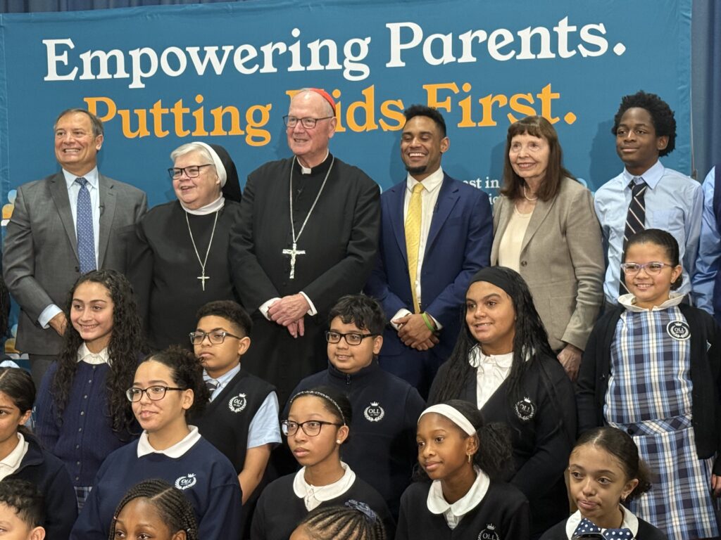Cardinal Timothy Dolan (center) was joined by (second left) Superintendent for Schools, Catholic Schools of the Archdiocese of New York, Sister Mary Grace Walsh, ASCJ, Ph.D., (far left) Anthony de Nicola, chairman, Invest in Education Foundation, (third right) Josiah Marquez, senior marketing associate at the Inner-City Scholarship Fund, (second right) Suzanne Kaszynski, principal, Our Lady of Lourdes School and students of Our Lady of Lourdes School at the Invest in Education Foundation event, October 16, 2025.