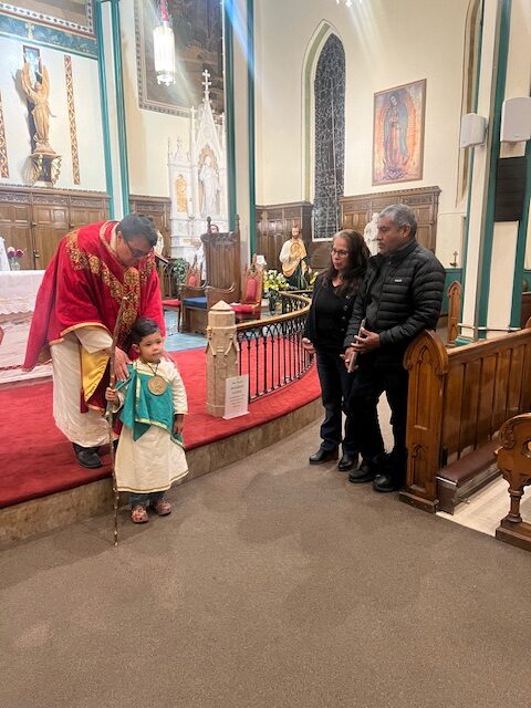 Father Arthur Rojas (left), a young parishioner, and his family of St. Mary-St. Peter Parish in Kingston celebrate the feast of St. Jude Thaddeus on October 28, 2025.