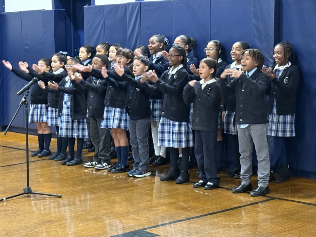Fourth grade students of Our Lady of Lourdes School in Harlem sing at an event on October 16, 2025.