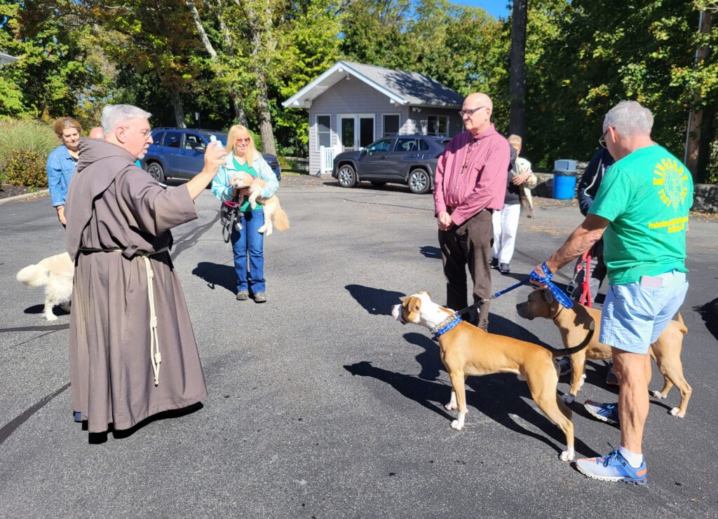 Father James Puglisi, SA, blesses family pets during the Franciscan Friars of the Atonement’s 2024 Feast of St. Francis celebration in Garrison.