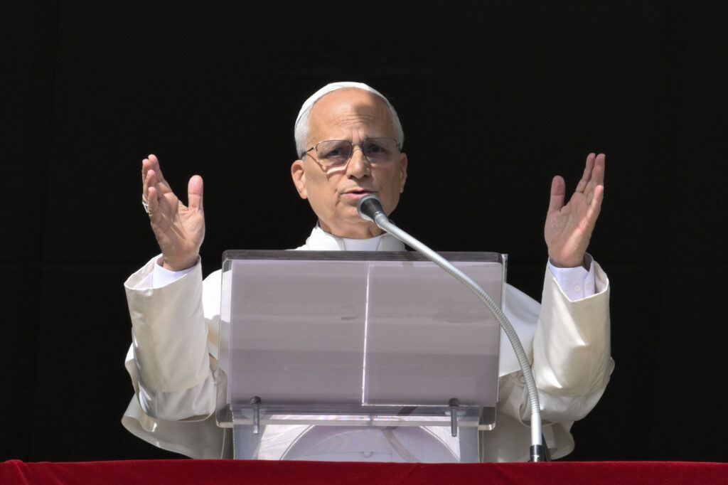 Pope Leo XIV, from the window of his studio in the Apostolic Palace, prepares to give his blessing to people gathered in St. Peter's Square at the Vatican to recite the Angelus prayer on the feast of All Souls, on November 2, 2025.