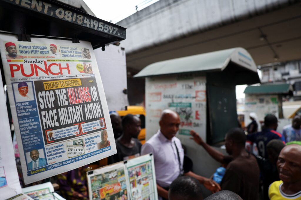 A newspaper with an article reporting U.S. President Donald Trump's message to Nigeria over the treatment of Christians hangs at a newspaper stand in Ojuelegba, Lagos, Nigeria. November 2, 2025. Trump said October 31 he would designate Nigeria as a "country of particular concern" in response to violence in that country perpetuated against predominantly Christian communities. On November 1, he threatened military action if that country's government didn't "move fast" to respond. Photo: OSV News photo/Sodiq Adelakun, Reuters