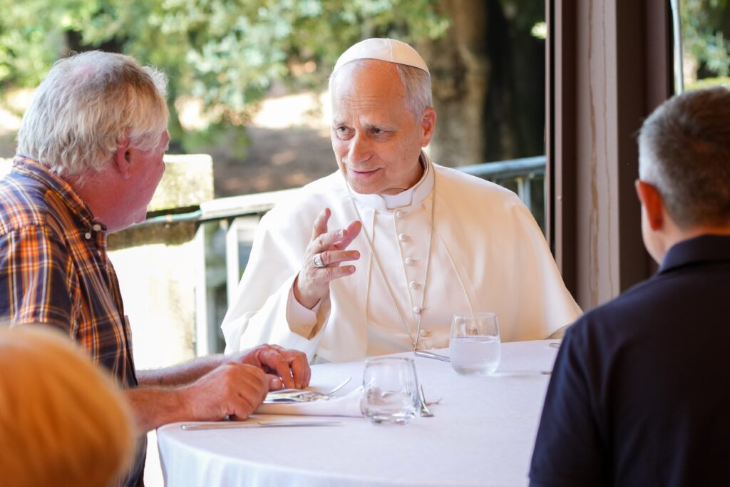 Pope Leo XIV shares a moment with guests assisted by the Albano diocesan Caritas agency during a luncheon at the Borgo Laudato Si’ in Castel Gandolfo, Italy, August 17, 2025.