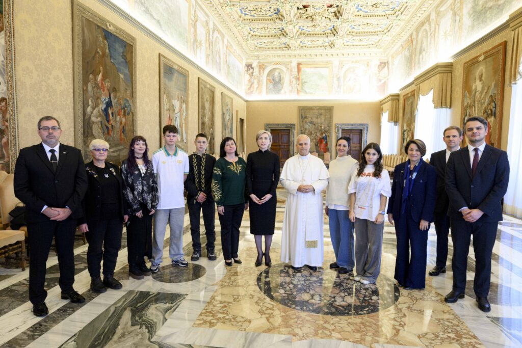 Pope Leo XIV poses for a photo with Ukrainian young people who have been returned to Ukraine after having been forcibly taken to Russia during a meeting in the Apostolic Palace at the Vatican on November 21, 2025.