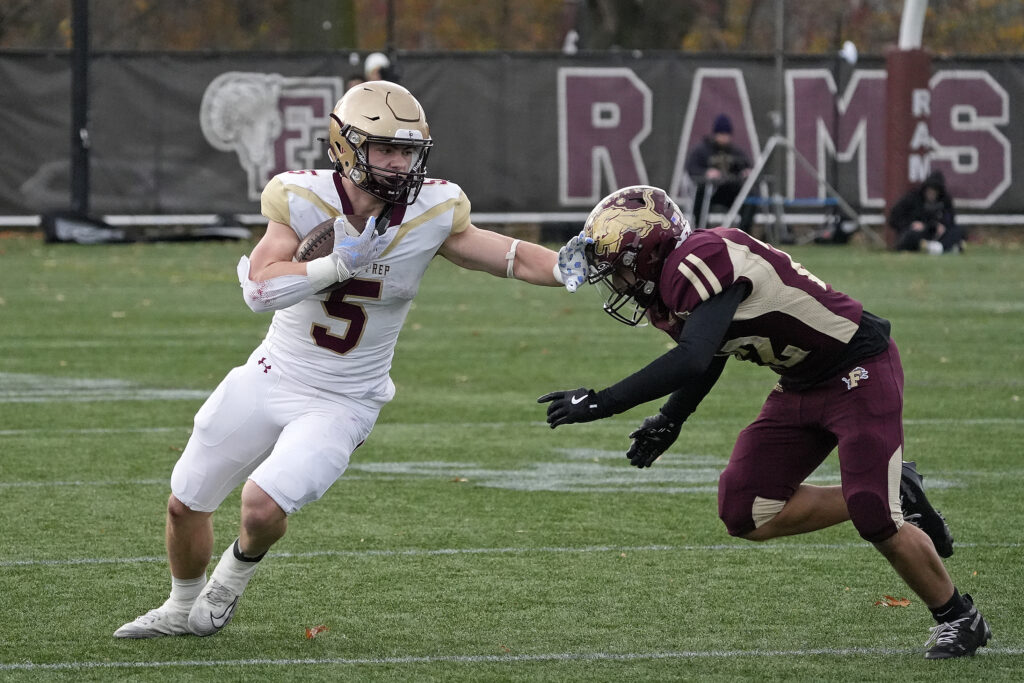 Iona Prep running back Crew Davis (5) eludes Monsignor Farrell High School defensive back Anthony Vento as he carries the ball during the Gaels' 42-20 victory in the CHSFL AAA championship game at Fordham University on Saturday, November 22, 2025.