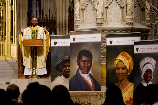 Father Kareem Smith addresses the congregation during the Archdiocese of New York's annual Black History Month Mass at St. Patrick's Cathedral in New York City February 4, 2024. The liturgy also marked the National Day of Prayer for the African American and African Family. At the front of the altar are images of four of six U.S. Black Catholics up for sainthood: Julia Greeley, left, Pierre Toussaint, Sister Thea Bowman and Mother Mary Elizabeth Lange. OSV News photo/Gregory A. Shemitz