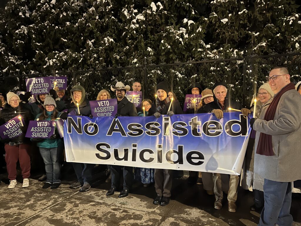 Opponents of New York state's proposed assisted suicide bill stand outside the governor's mansion in Albany, December 3, 2025, for a candlelight vigil urging for Governor Kathy Hochul to veto the bill passed by the Legislature June 9. Hochul indicated she would sign the bill.