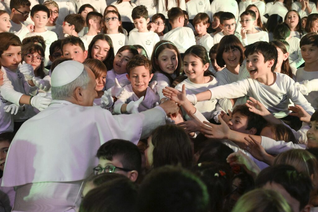 Pope Leo XIV shakes hands with students at the Pontifical Paul VI School in Castel Gandolfo, Italy, after he attended their Christmas concert in the school gym on December 16, 2025.