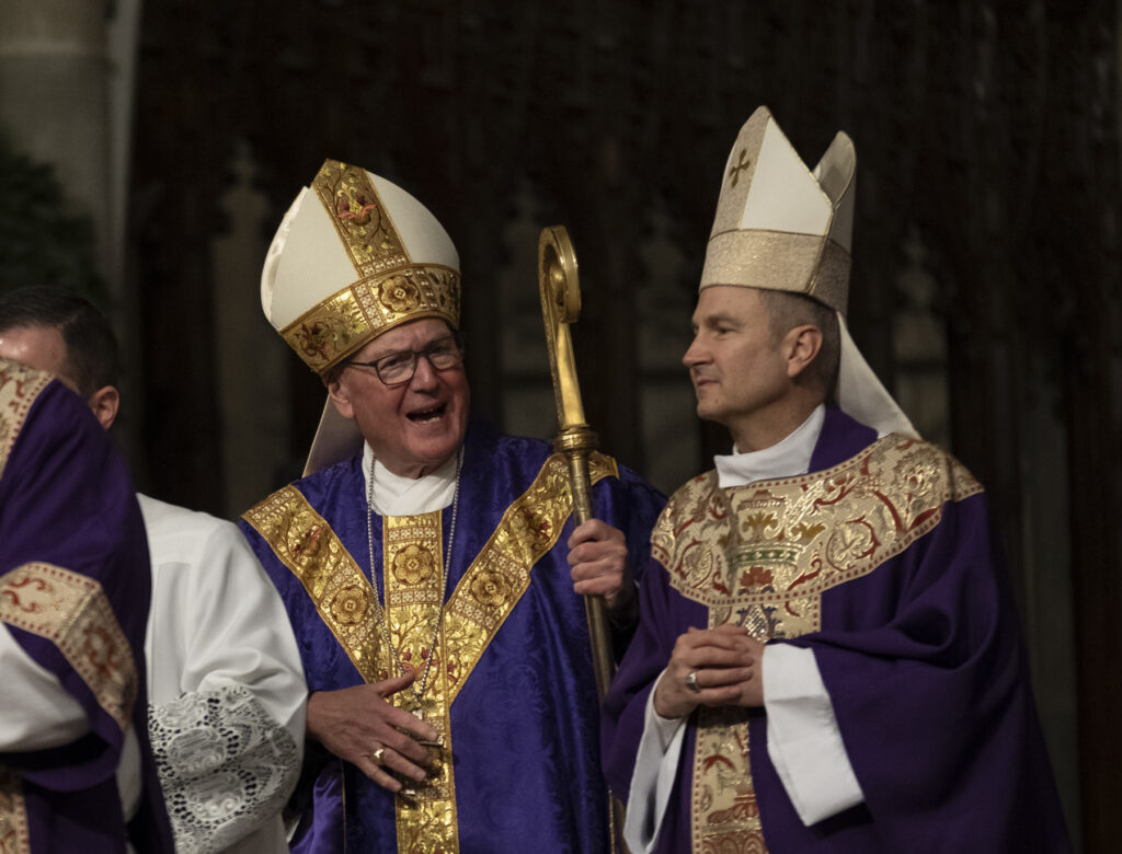 Cardinal Timothy Dolan (left) talks with Archbishop-designate Ronald Hicks after Mass at St. Patrick’s Cathedral in Manhattan on December 18, 2025.