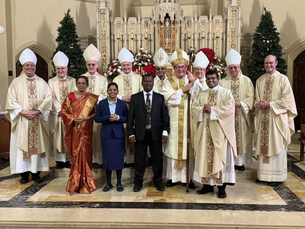 Father Rajesh Ravi (front row, right) joins members of his family, Cardinal Timothy Dolan (center), and bishops from the Archdiocese of New York and Dioceses of Tuticorin, Tamil Nadu, India, Brooklyn, and Rockville Centre, following his ordination at St. Augustine’s Church in Larchmont, December 20, 2025.