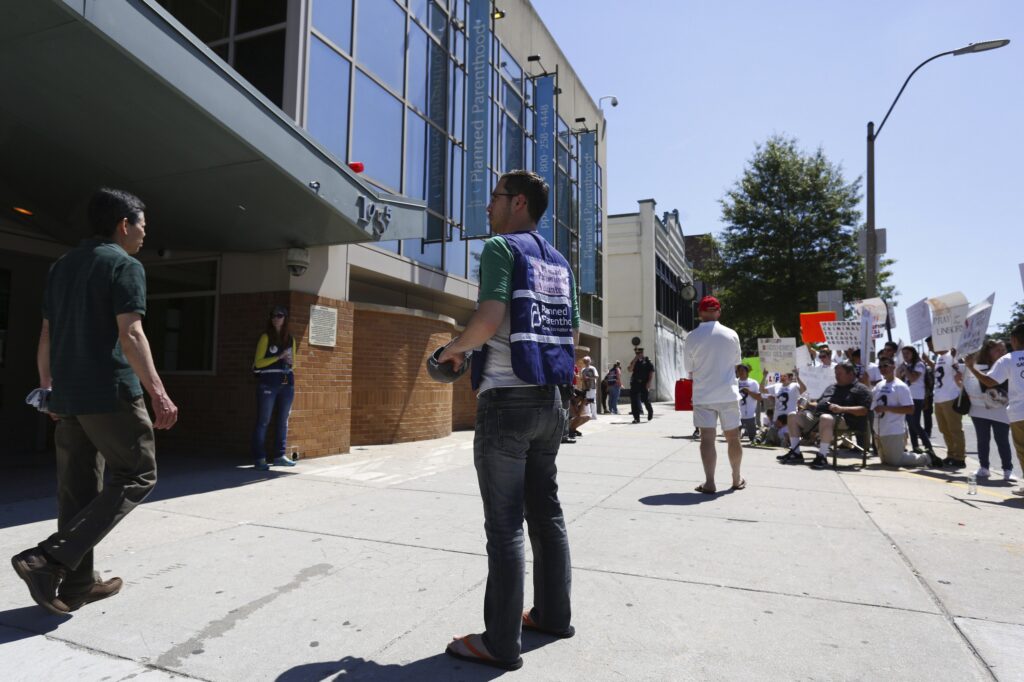A volunteer stands in front of a Planned Parenthood clinic in Boston, Massachusetts, on June 28, 2014.
