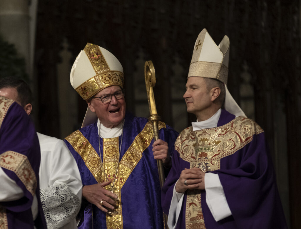 Cardinal Timothy Dolan (left) talks with Archbishop-designate Ronald Hicks after Mass at St. Patrick’s Cathedral in Manhattan on December 18, 2025.