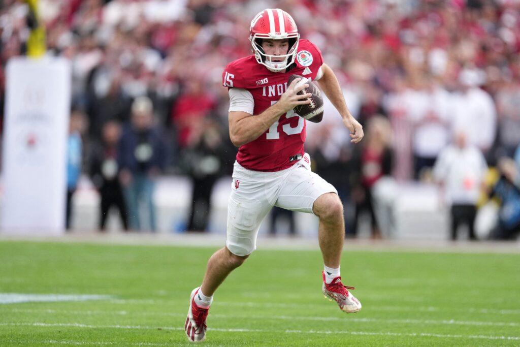 Indiana Hoosiers quarterback Fernando Mendoza (15), a Catholic and the 2025 Heisman Trophy winner, runs against the Alabama Crimson Tide in the first half of the 2026 Rose Bowl and quarterfinal game of the College Football Playoff on New Year's Day at Rose Bowl Stadium in Pasadena, Calif. The Hosiers defeated Alabama 38-3.