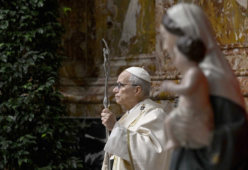 Pope Leo XIV stands with his crosier as he celebrates an early morning Mass in St. Peter's Basilica at the Vatican on January 8, 2026.