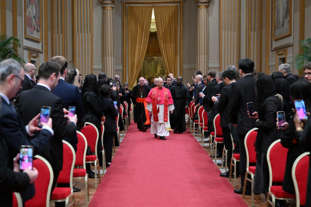 Pope Leo XIV walks down the aisle to meet with members of the diplomatic corps accredited to the Vatican at the Apostolic Palace at the Vatican on January 9, 2026.