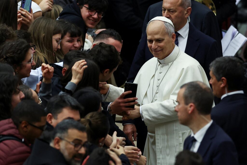 Pope Leo XIV takes selfies with participants after a meeting with the youth of the Diocese of Rome in the Paul VI Hall at the Vatican January 10, 2026.