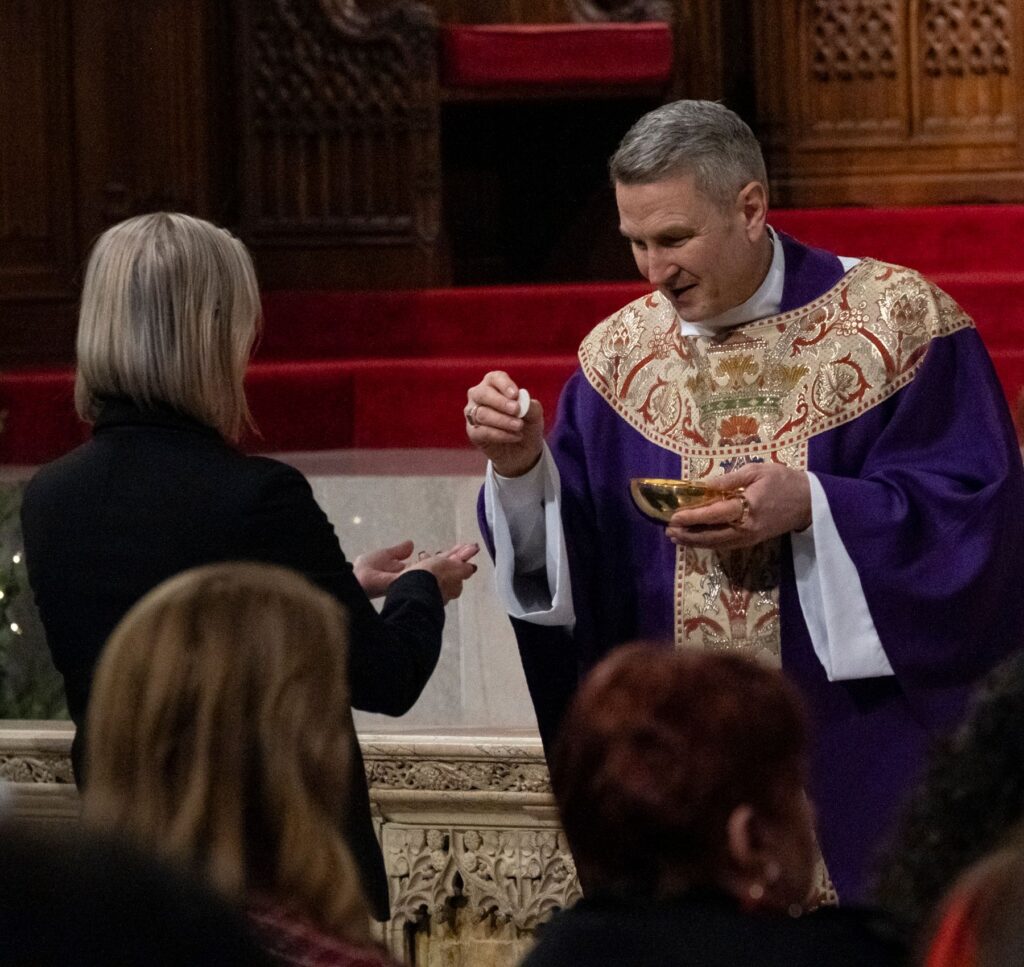 Archbishop-designate Ronald A. Hicks distributes communion at the Archdiocese of New York staff Mass on December 18, 2025 at St. Patrick's Cathedral.