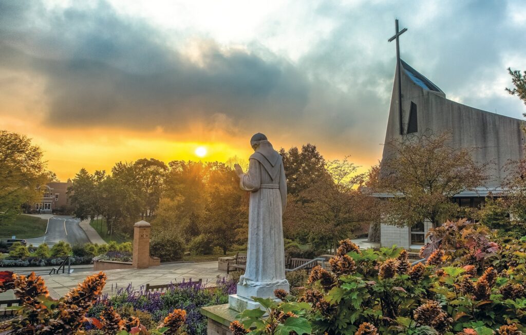 A file photo shows a statue and church on the campus of the Franciscan University of Steubenville, Ohio.