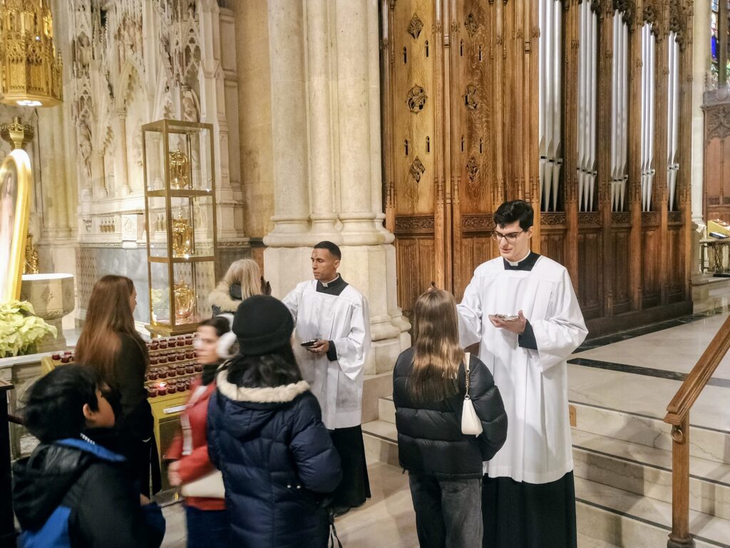 Richard Nuñez, left, and Gabriel Gojcaj, seminarians at St. Joseph’s Seminary in Yonkers, administering ashes to the faithful during Ash Wednesday at St. Patrick’s Cathedral, February 18, 2026.