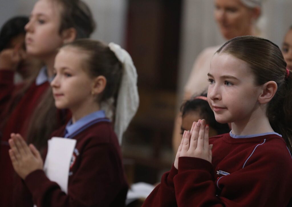 Young choir members pray during a Mass at Dublin's St. Mary's Pro Cathedral November 14, 2025, marking the bicentenary of the church's dedication in 1825 and the feast of the city's patron, St. Laurence O'Toole.
