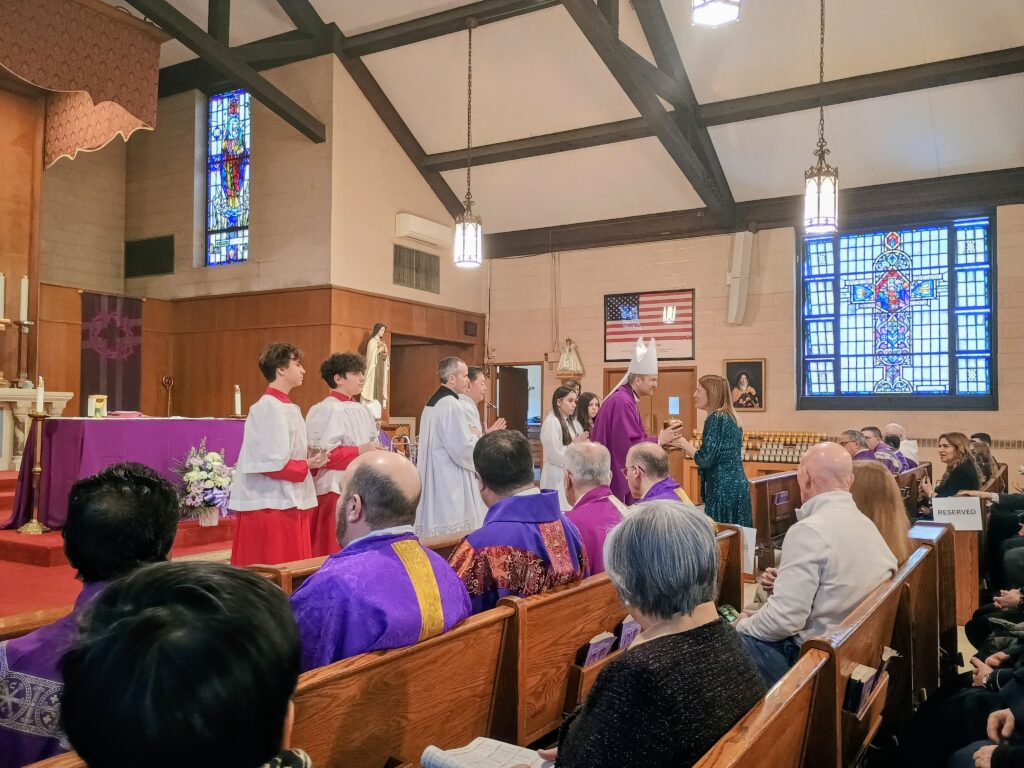 Archbishop Ronald Hicks receives the gifts at the 100th Anniversary Mass of the Church of St. Teresa of the infant Jesus on Staten Island, Saturday, March 7, 2026. Photo by: Armando Machado/The Good Newsroom