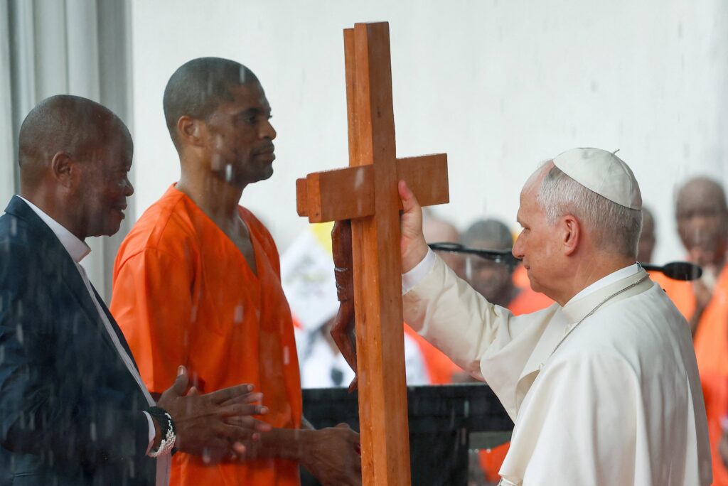Pope Leo XIV receives a cross from an inmate during the pontiff's visit to Bata prison in Equatorial Guinea, April 22, 2026.