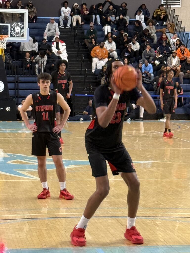 Archbishop Stepinac High School senior guard Jack Coco (#11) watches as teammate Adonis Ratliff takes a foul shot, March 22, 2026.