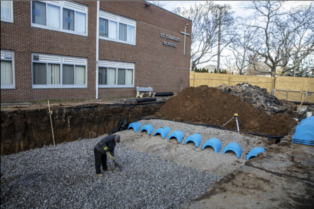 A worker digs as part of a stormwater management project at St. Charles School in the Oakwood section of Staten Island in this undated photo.