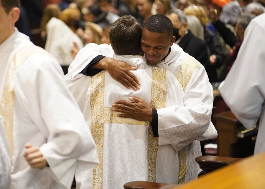 Callistus Ibeh, right, exchanges the sign of peace with fellow Diocese of Brooklyn, N.Y., seminarian Juan Herrera-Posada during their ordination to the transitional diaconate at St. Joseph's Seminary in Yonkers, N.Y., Nov. 9, 2024. Eight seminarians completing their preparation for the priesthood were ordained at the Mass: five for the Diocese of Brooklyn and three for Archdiocese of New York. The liturgy was celebrated on the final day of National Vocations Awareness Week.
