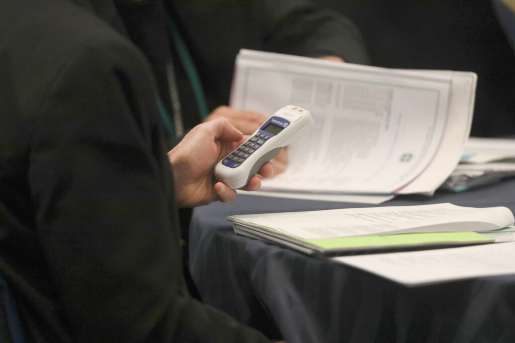 A bishop uses an electronic voting device during a Nov. 14, 2023, session of the fall general assembly of the U.S. Conference of Catholic Bishops in Baltimore.