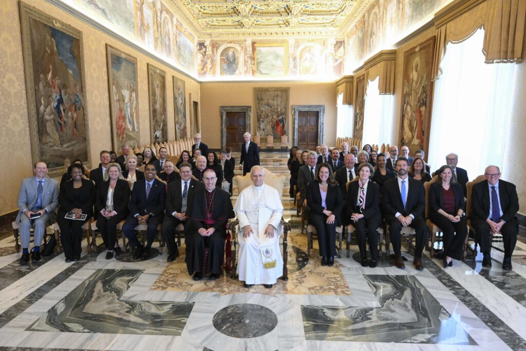 Pope Leo XIV sits for a photo with members of Catholic Charities USA as he meets with the agency's directors May 4, 2026, in the Consistory Hall of the Apostolic Palace at the Vatican.
