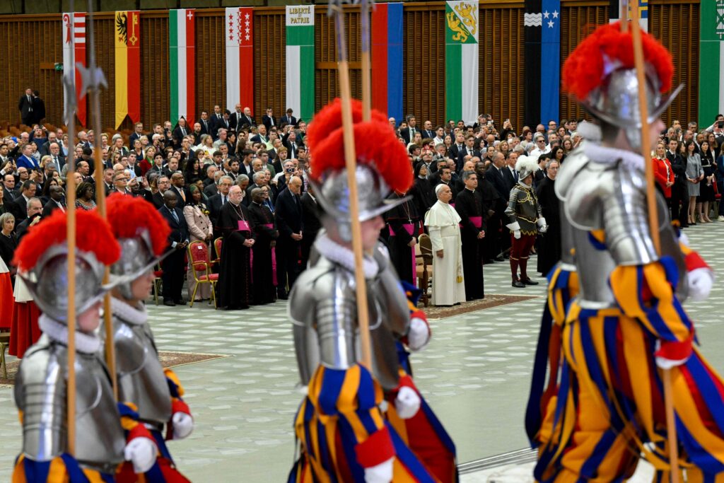 Swiss Guards enter the Paul VI Audience Hall at the Vatican at the start of the swearing-in ceremony for 28 new Swiss Guard recruits as Pope Leo XIV looks on May 6, 2026.