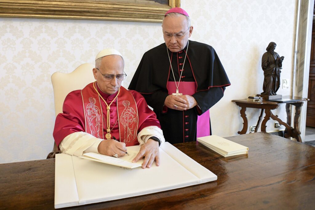 Pope Leo XIV signs his first apostolic exhortation, "Dilexi Te" ("I Have Loved You"), in the library of the Apostolic Palace at the Vatican Oct. 4, 2025.