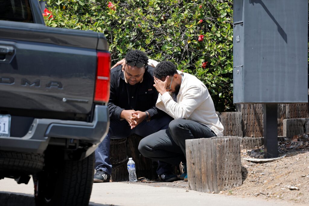 Men console each other near the scene of a shooting at the Islamic Center in San Diego May 18, 2026. Two teenage shooters opened fire at a the mosque and killed three men -- then killed themselves a few blocks away -- in an attack police are investigating as a hate crime. Photo: OSV News photo/Mike Blake, Reuters