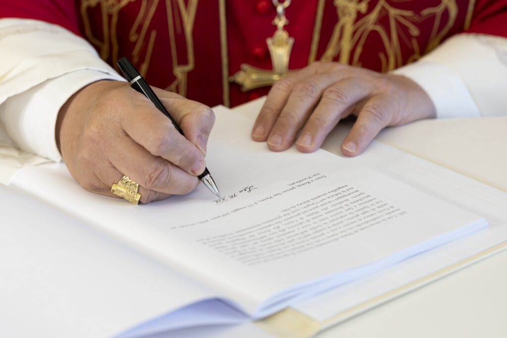 Pope Leo XIV signs "Magnifica Humanitas" at the Vatican's Synod Hall May 15, 2026. The first encyclical of his papacy, officially released May 25, focuses on the rise of artificial intelligence.