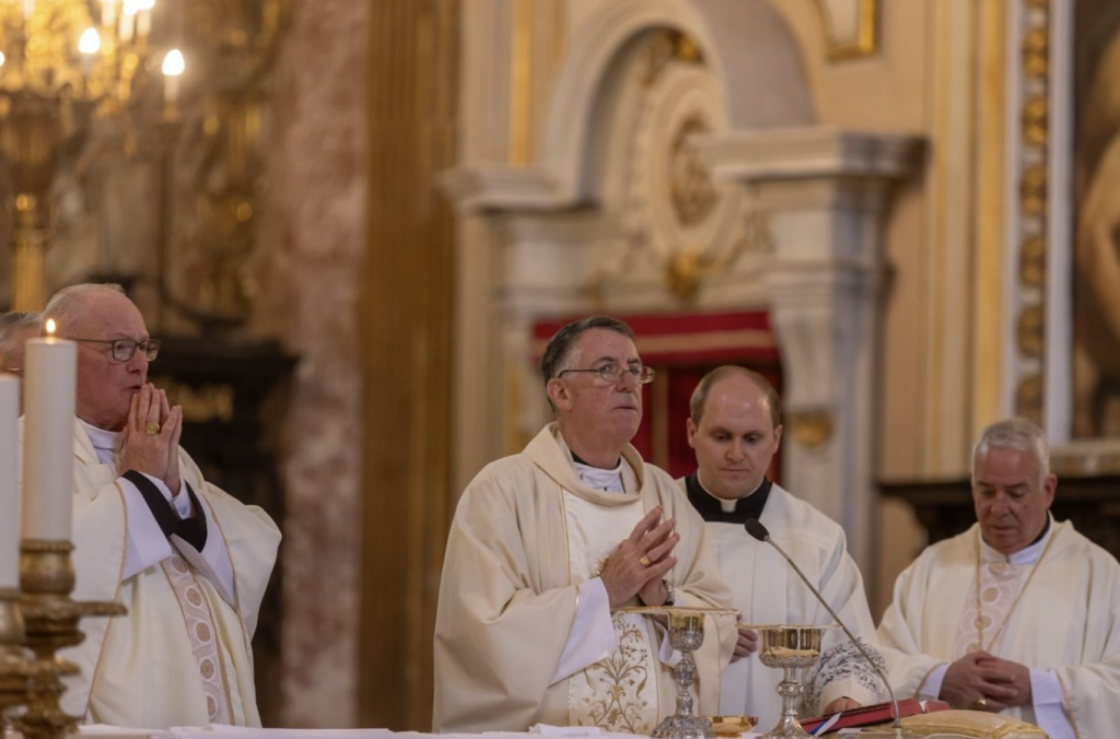 Archbishop James Checchio presides over the Mass for the members and staff of the Papal Foundation, including Cardinal Timothy Dolan (left).
