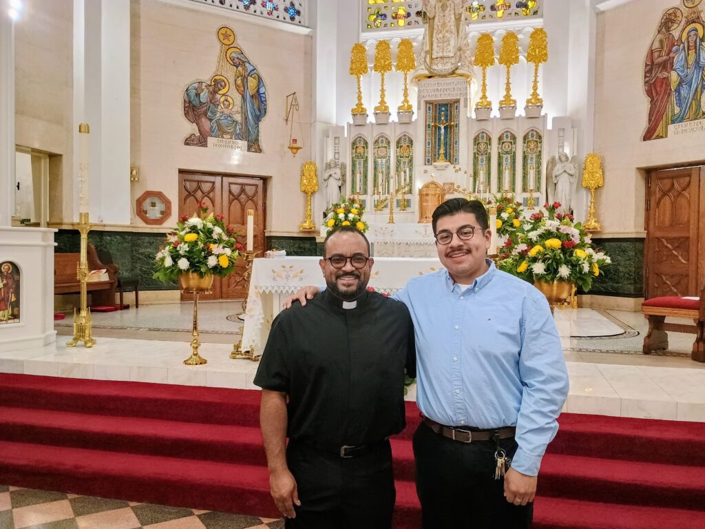 Father Osvaldo Hernandez and Kevin Serrano Lopez near the sanctuary of Our Lady of Mercy Church in the Bronx, May 12, 2026.