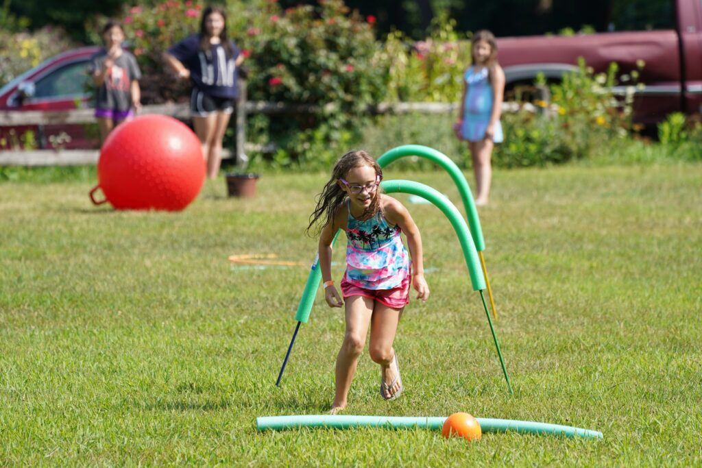 A girl navigates an obstacle course at Camp Alvernia in Centerport, July 26, 2020.