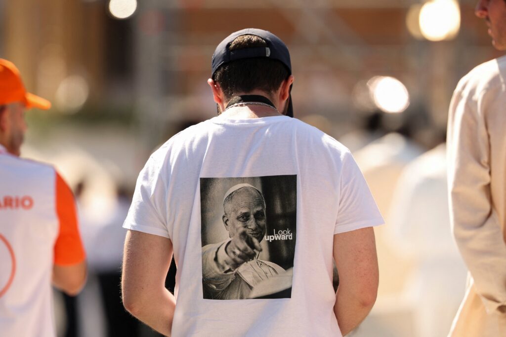 A man wears a T-shirt with an image of Pope Leo XIV as the pontiff celebrates Mass at Plaza de Cibeles in Madrid June 7, 2026, during his apostolic journey to Spain.