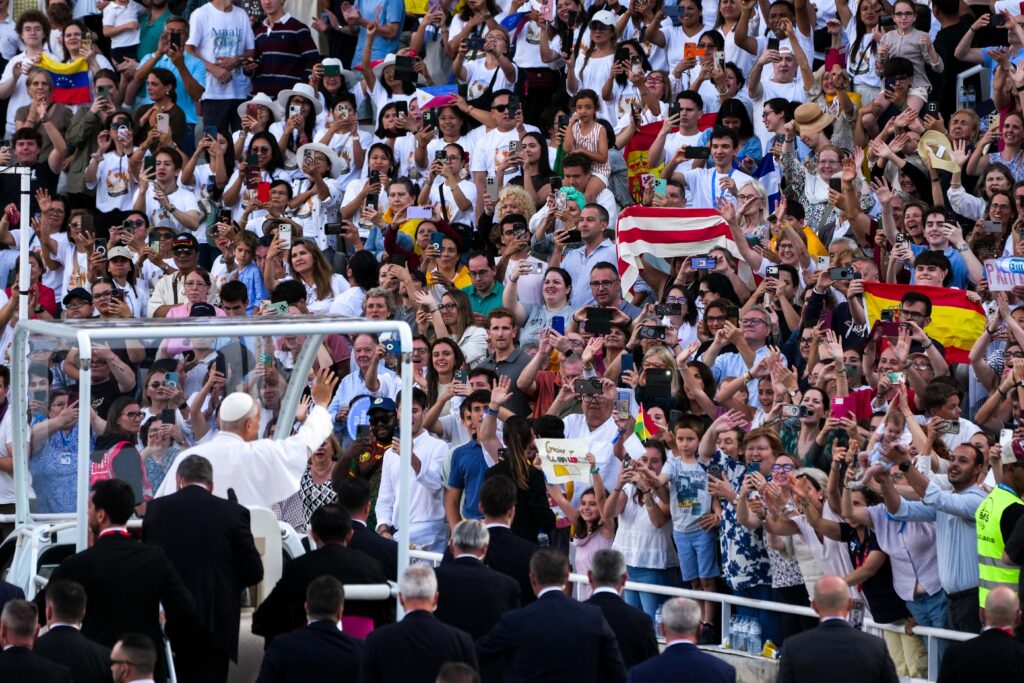 Pope Leo XIV rides through the Lluís Companys Olympic Stadium in Barcelona June 9, 2026, greeting young people gathered for a prayer vigil.