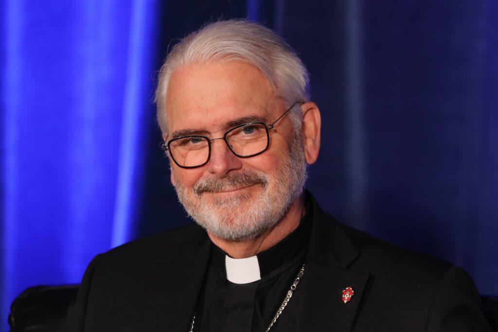 Archbishop Paul S. Coakley of Oklahoma City, president of the U.S. Conference of Catholic Bishops, smiles during a news briefing at a June 10, 2026, session of the annual spring meeting of the USCCB in Orlando, Fla.