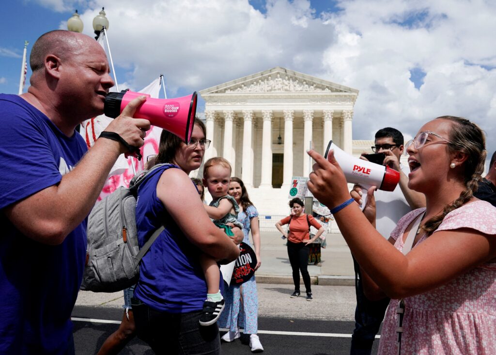 A pro-life activist and a supporter of legal abortion square off with megaphones in front of the U.S. Supreme Court in Washington June 24, 2023, the first anniversary the court's 2022 ruling in Dobbs v. Jackson Women's Health Organization, overturning Roe v. Wade, which legalized abortion nationwide in 1973. On the fourth anniversary of Dobbs June 24, 2026, the U.S. bishops' pro-life chair and pro-life leaders pointed to abortion pills as among key challenges for protecting the lives of unborn children.