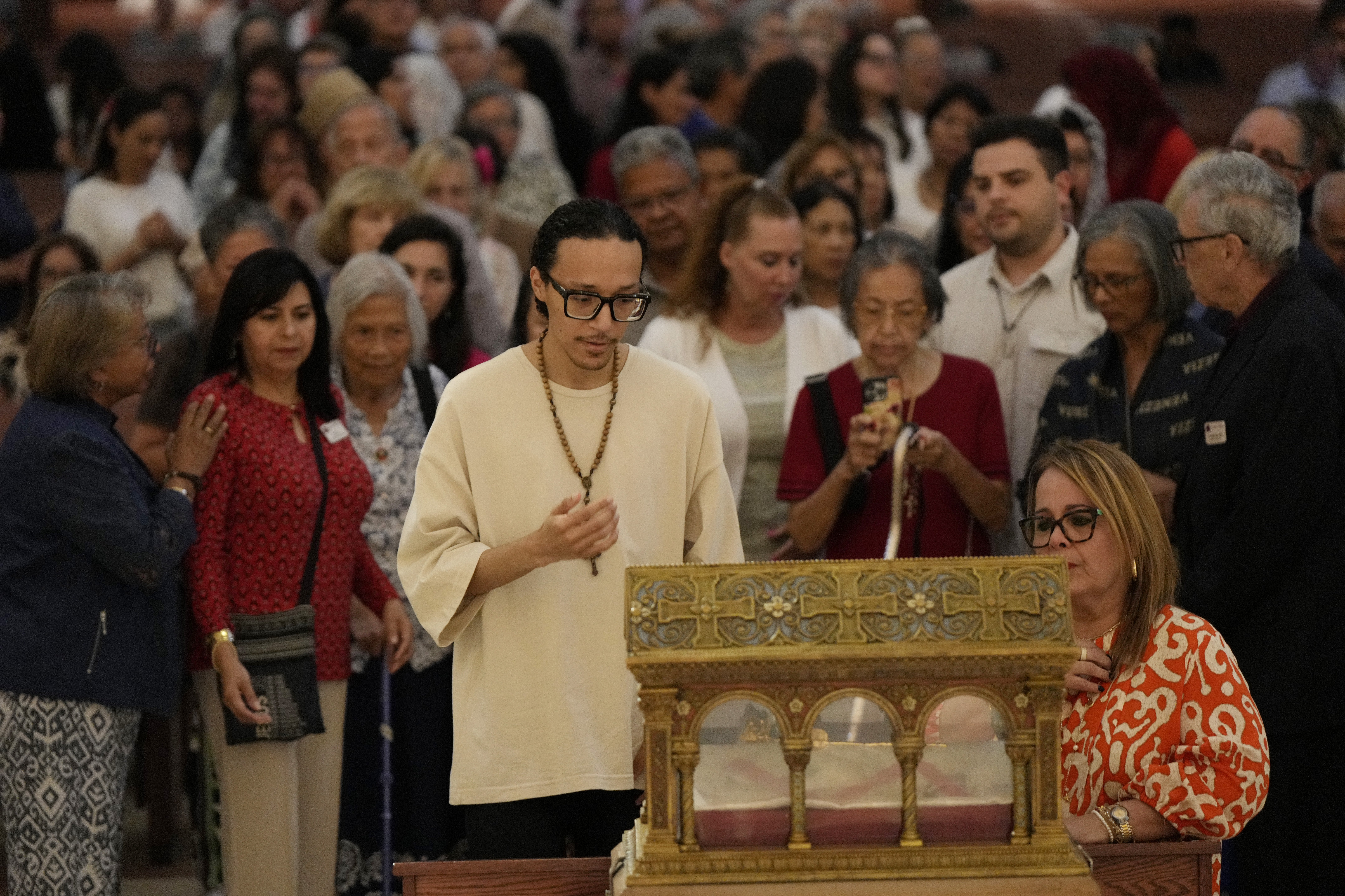People venerate the major relics of St. Margaret Mary Alacoque at St. James Cathedral in Orlando, Fla., June 12, 2026. The Knights of Columbus brought the relics of the French Visitation nun and mystic to the United States for a multi-city tour. The saint experienced visions of Jesus revealing his Sacred Heart.