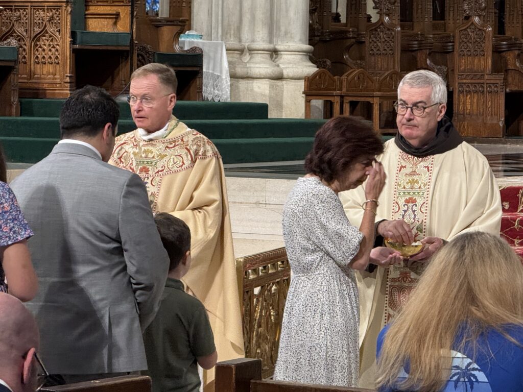 Archdiocese of New York Vicar General Bishop Edmund J. Whalen (left) and Father Brian Jordan, OFM, distribute communion at the annual Construction Mass at St. Patrick's Cathedral, June 7, 2026.