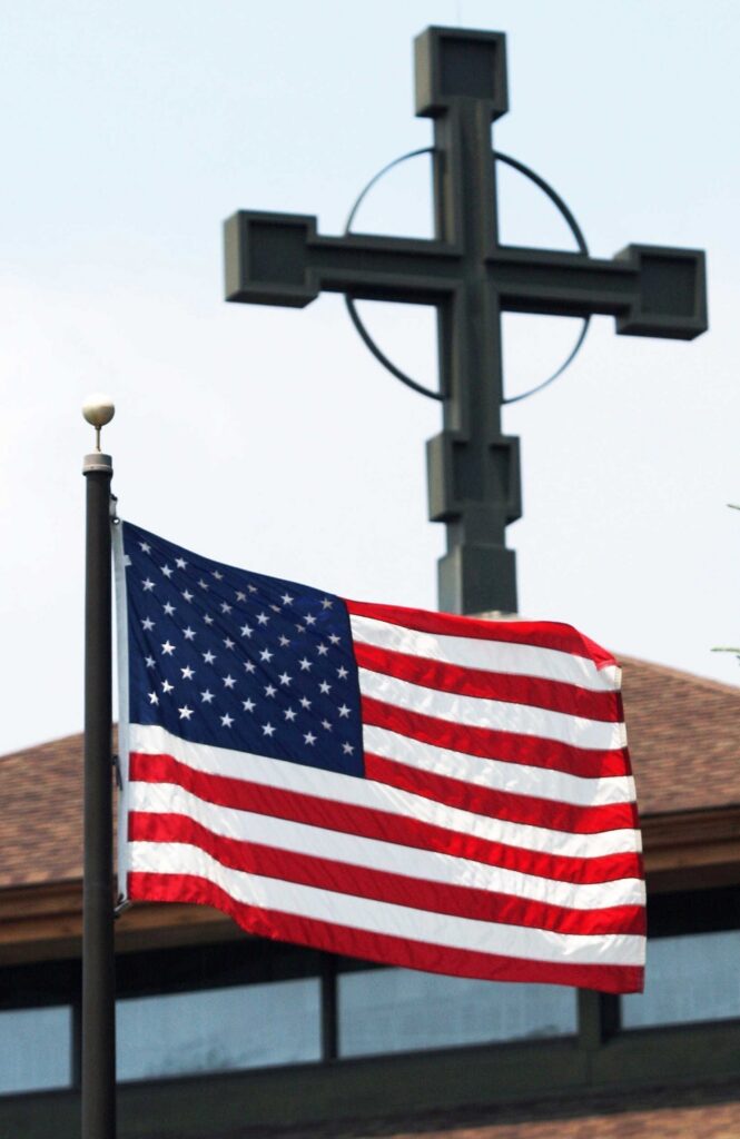 A file photo shows an American flag flying outside Our Lady Queen of Martyrs Church in Centerport.