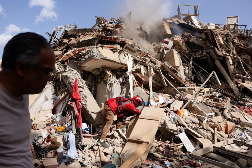 Juan Carlos Gomez, a firefighter from Caracas, looks for his sister, Katiuska Hernandez, and nephew Brett Roude, amid the rubble of a building in La Guaira, Venezuela, June 25, 2026, following 7.2 and 7.5 magnitude earthquakes that rocked the country June 24.