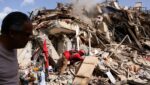 Juan Carlos Gomez, a firefighter from Caracas, looks for his sister, Katiuska Hernandez, and nephew Brett Roude, amid the rubble of a building in La Guaira, Venezuela, June 25, 2026, following 7.2 and 7.5 magnitude earthquakes that rocked the country June 24.