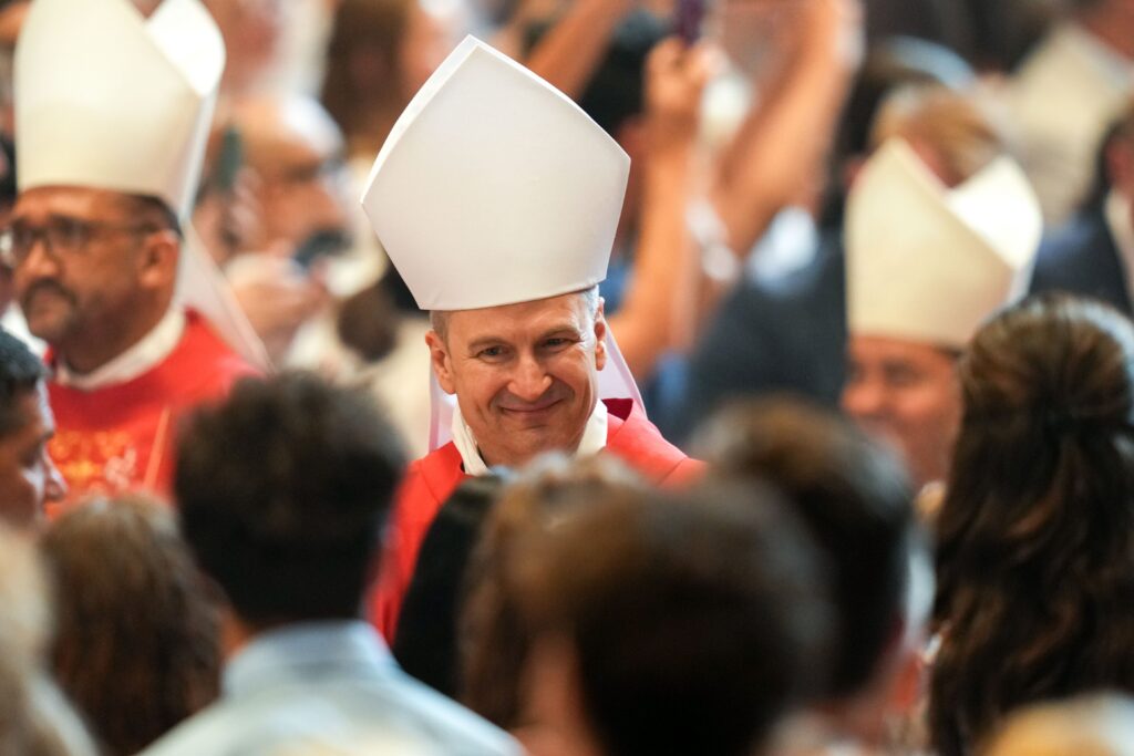 Archbishop Ronald A. Hicks of New York smiles as he processes into St. Peter’s Basilica at the Vatican June 29, 2026, for Mass with Pope Leo XIV on the feast of Sts. Peter and Paul. The pope was to bless palliums for 35 new metropolitan archbishops during the Mass, including four from the United States.