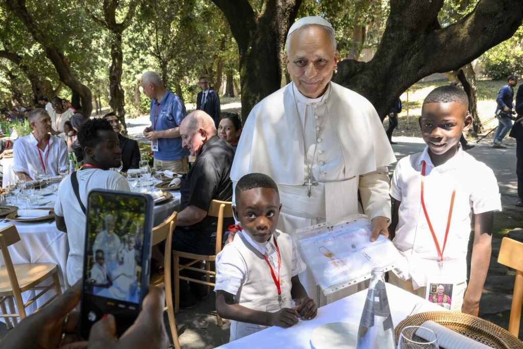 Pope Leo XIV poses for a photo with two young boys at a lunch with vulnerable people from the Diocese of Rome at Borgo Laudato Si, in the pontifical gardens of Castel Gandolfo, Italy, July 11, 2026.